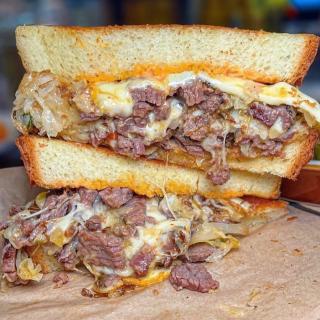 The “Reuben” Sandwich - Our smoked brisket sliced thin, chopped and grilled with sauerkraut, Muenster cheese, and Butcher’s sauce on Texas toast.